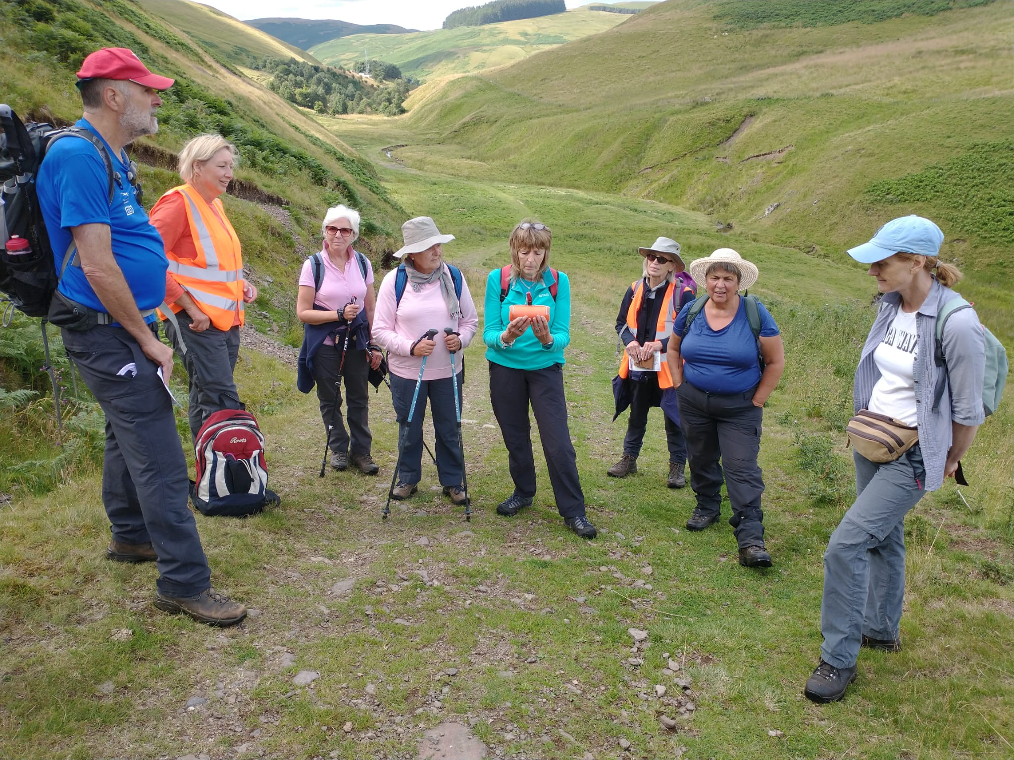 A group of people listening to a tour guide - OOT Walk, Bailiffgate Museum