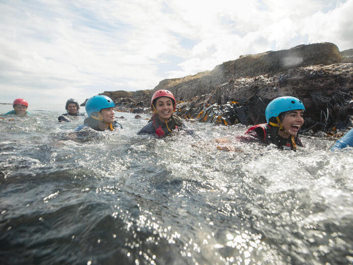 Teens coasteering in the North East of England at Beadnell.