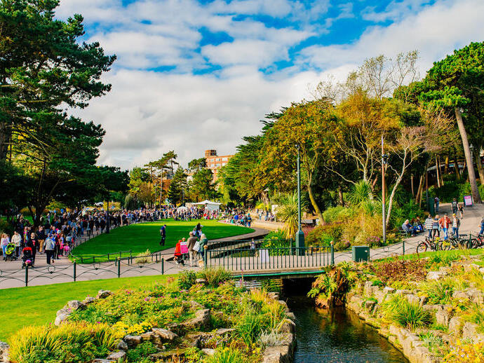 People walking in a park on a sunny day.