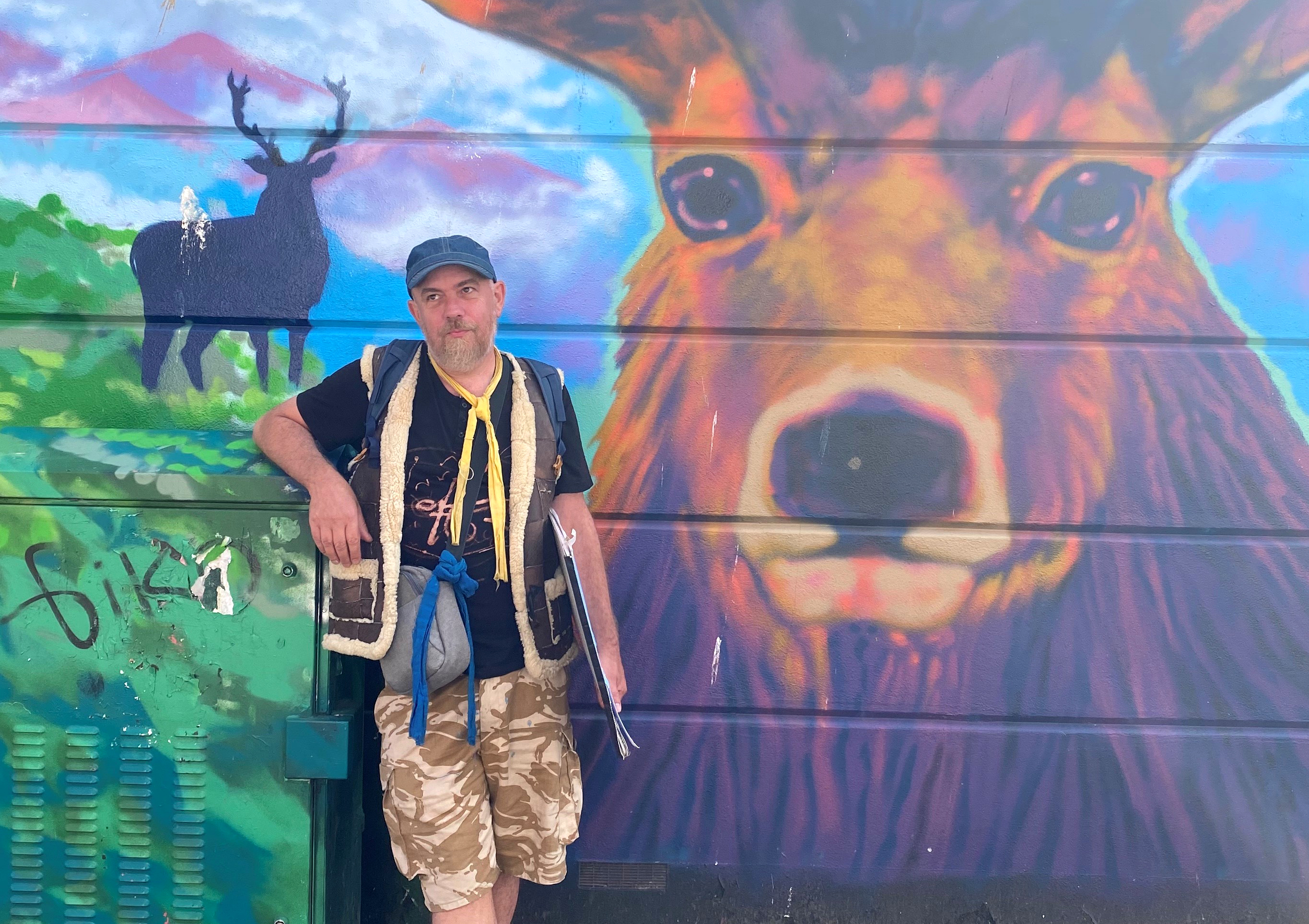 A tour guide highlighting Brighton's graffitti art on a tour