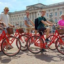 Group of people on bicycles on an Old London Tour in front of Buckingham Palace