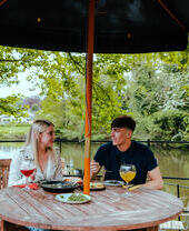 Una coppia che cena in riva al fiume