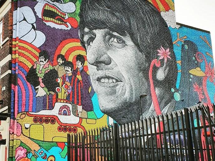 Grafitti art of the Beatles, prominently featuring Ringo Starr, on a wall in Liverpool
