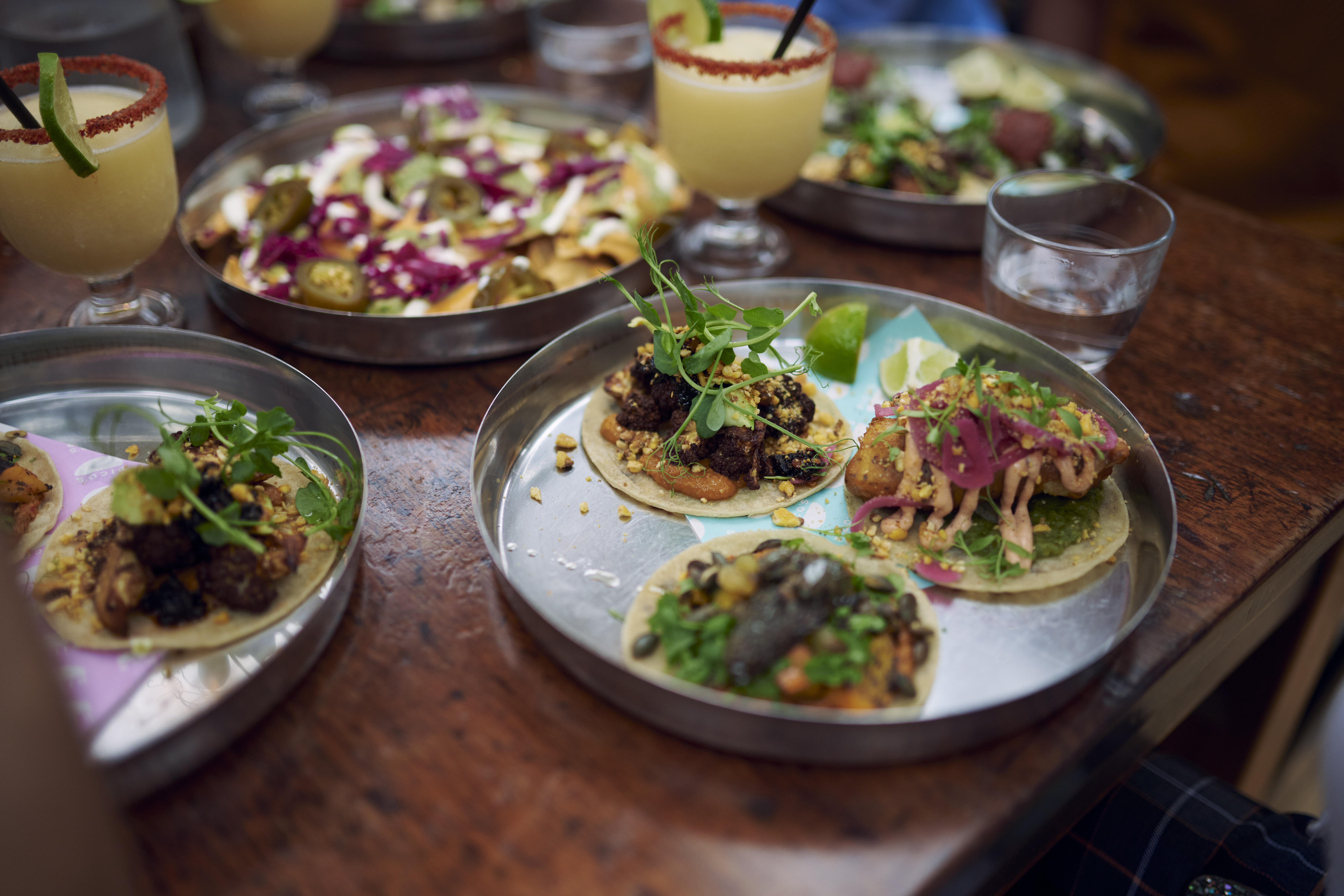Plates of food on a table in a restaurant at a food court