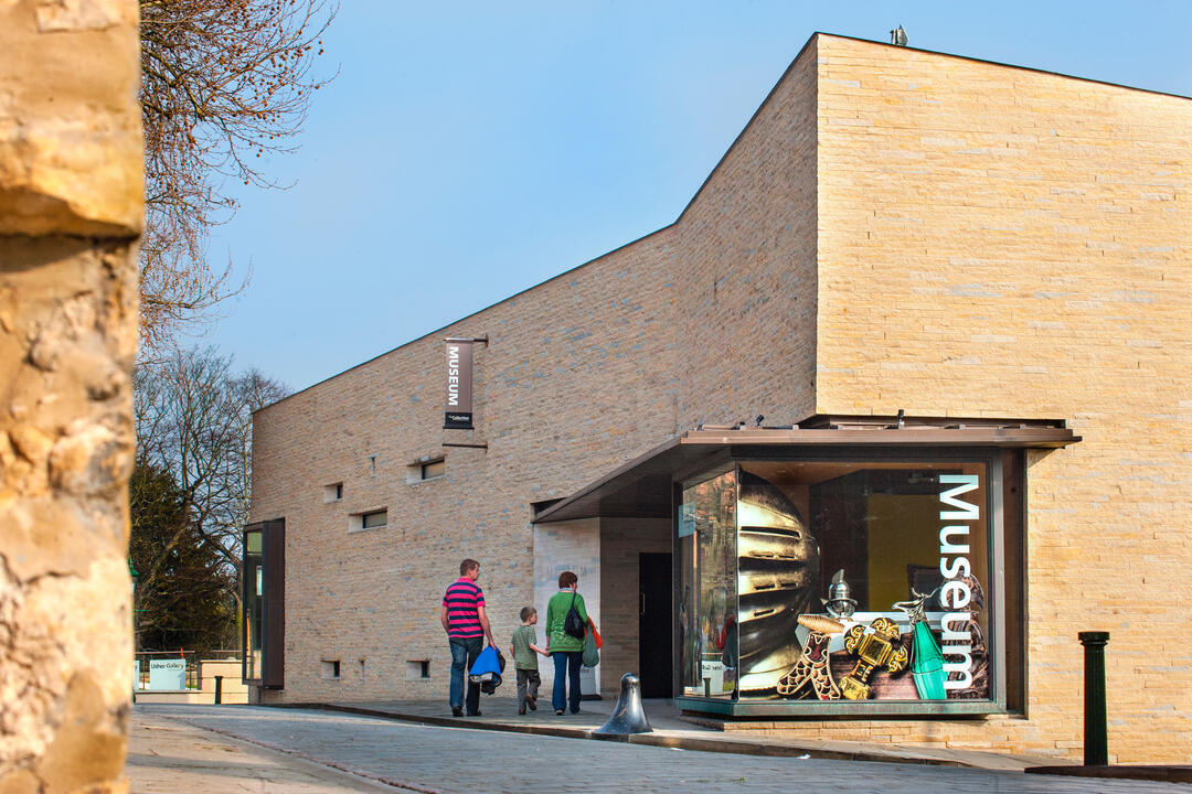 A group of people looking at an exhibit on a tour of The Collection in Lincolnshire