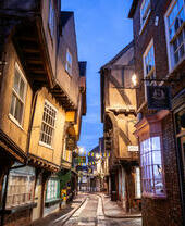 A cobbled shopping street at night.