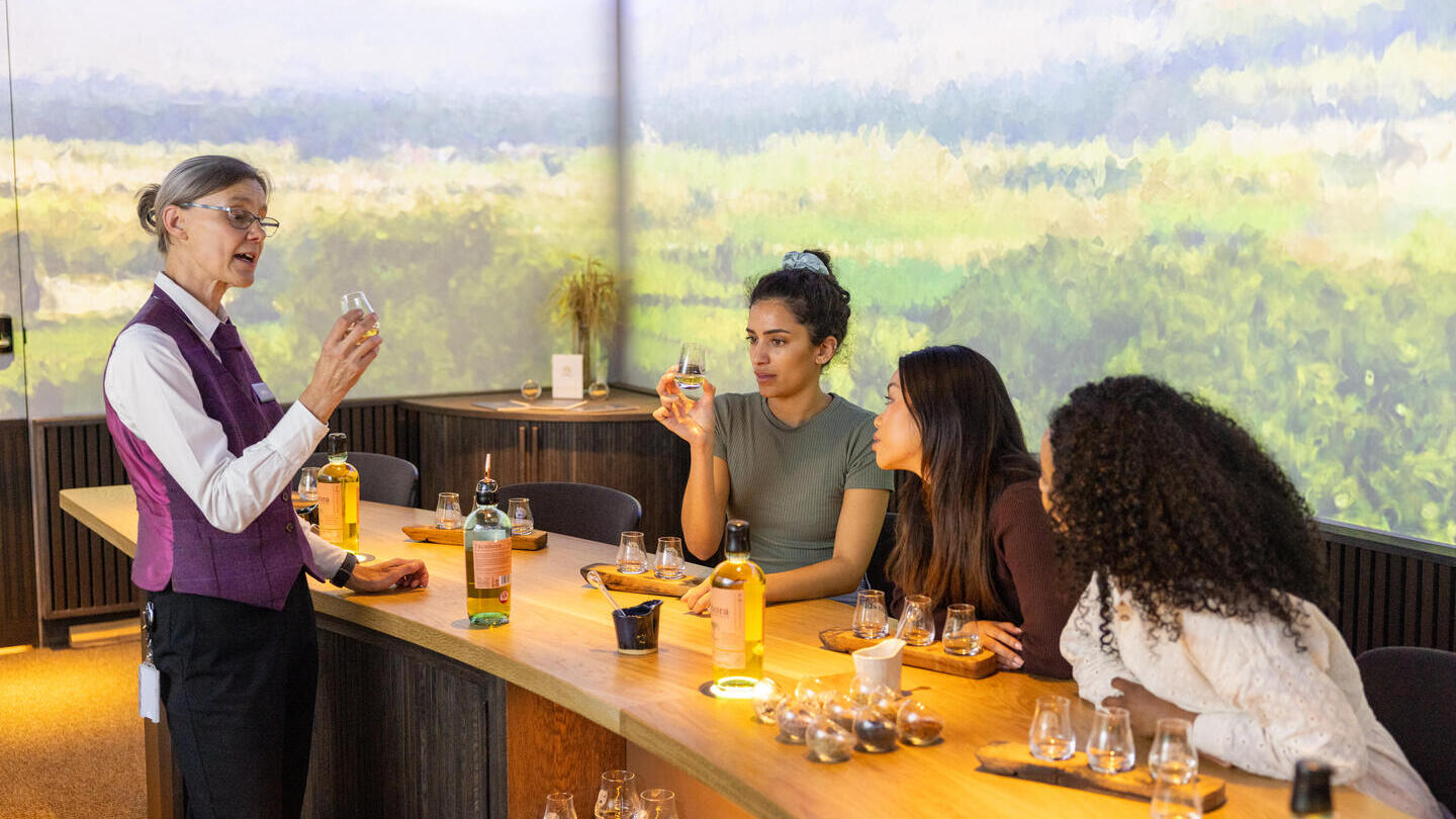 Three women having a tasting session at a whisky distillery