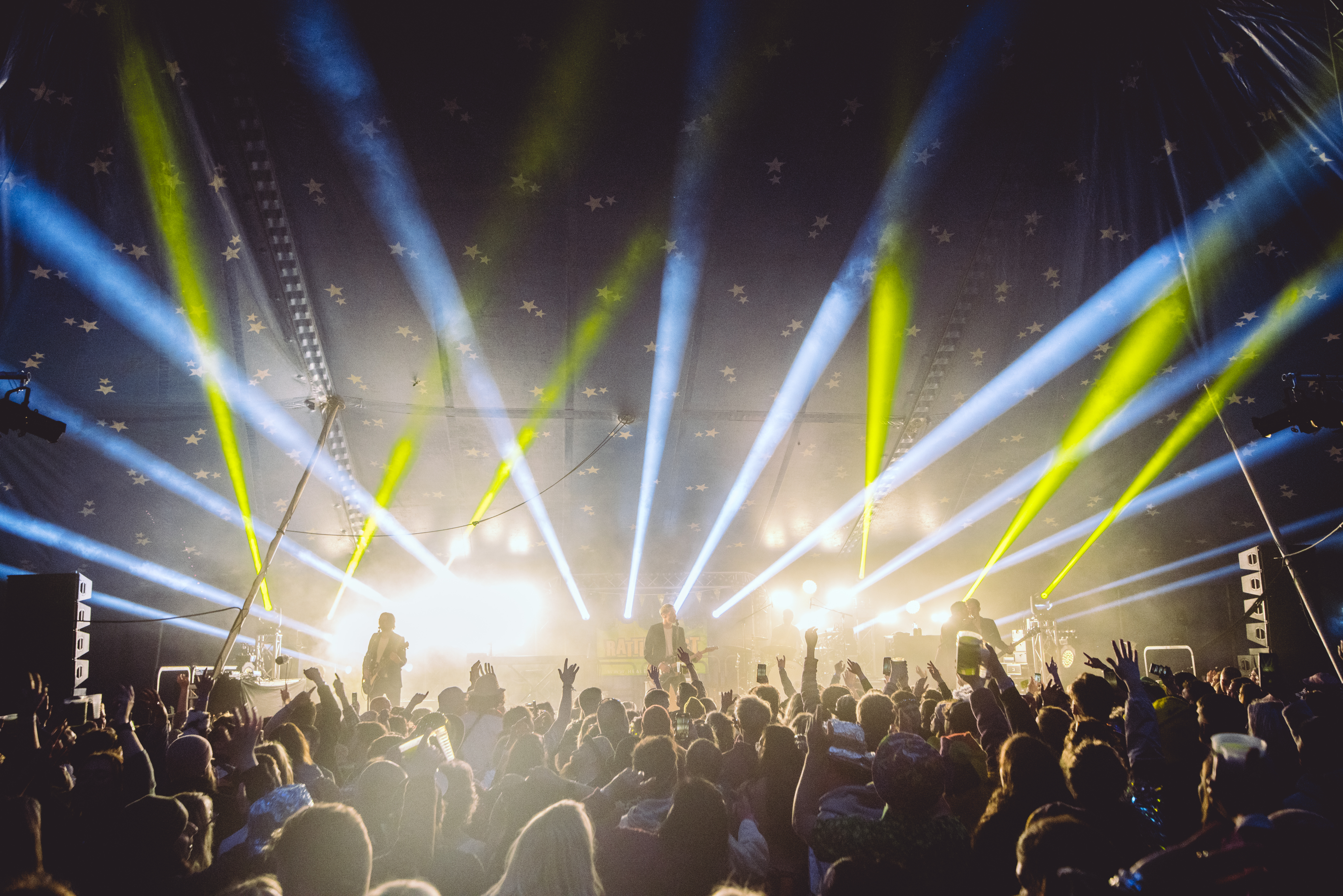 A band performing on stage at Rattler Festival in Cornwall