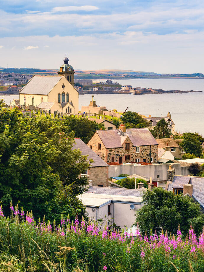 Landscape view of a harbourside town and the ocean.