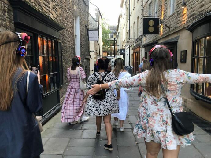 A group of people on a guided tour through the historic streets of Bath