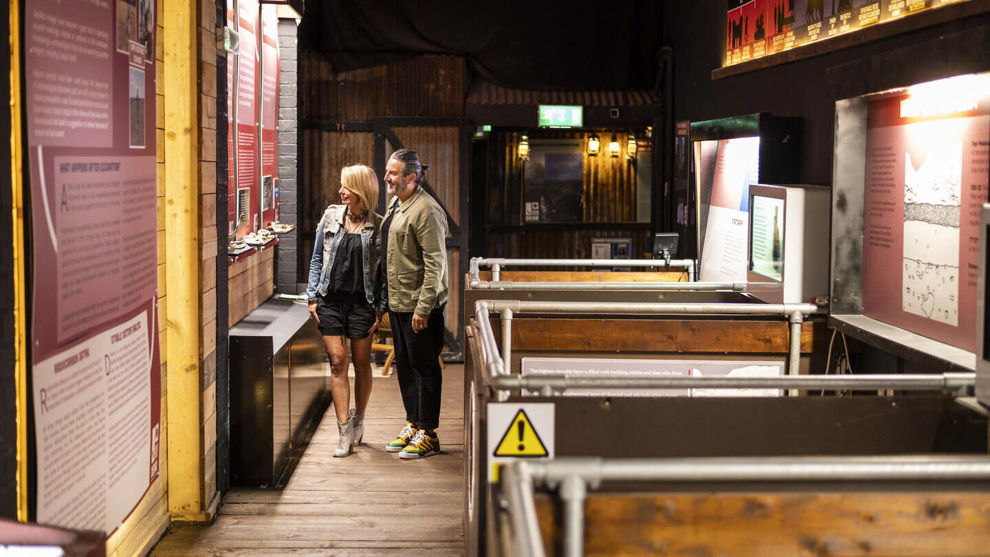 Two people looking at exhibits at the Deva Roman Experience in Chester