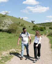 A man and woman walking along the National Trust Black Down