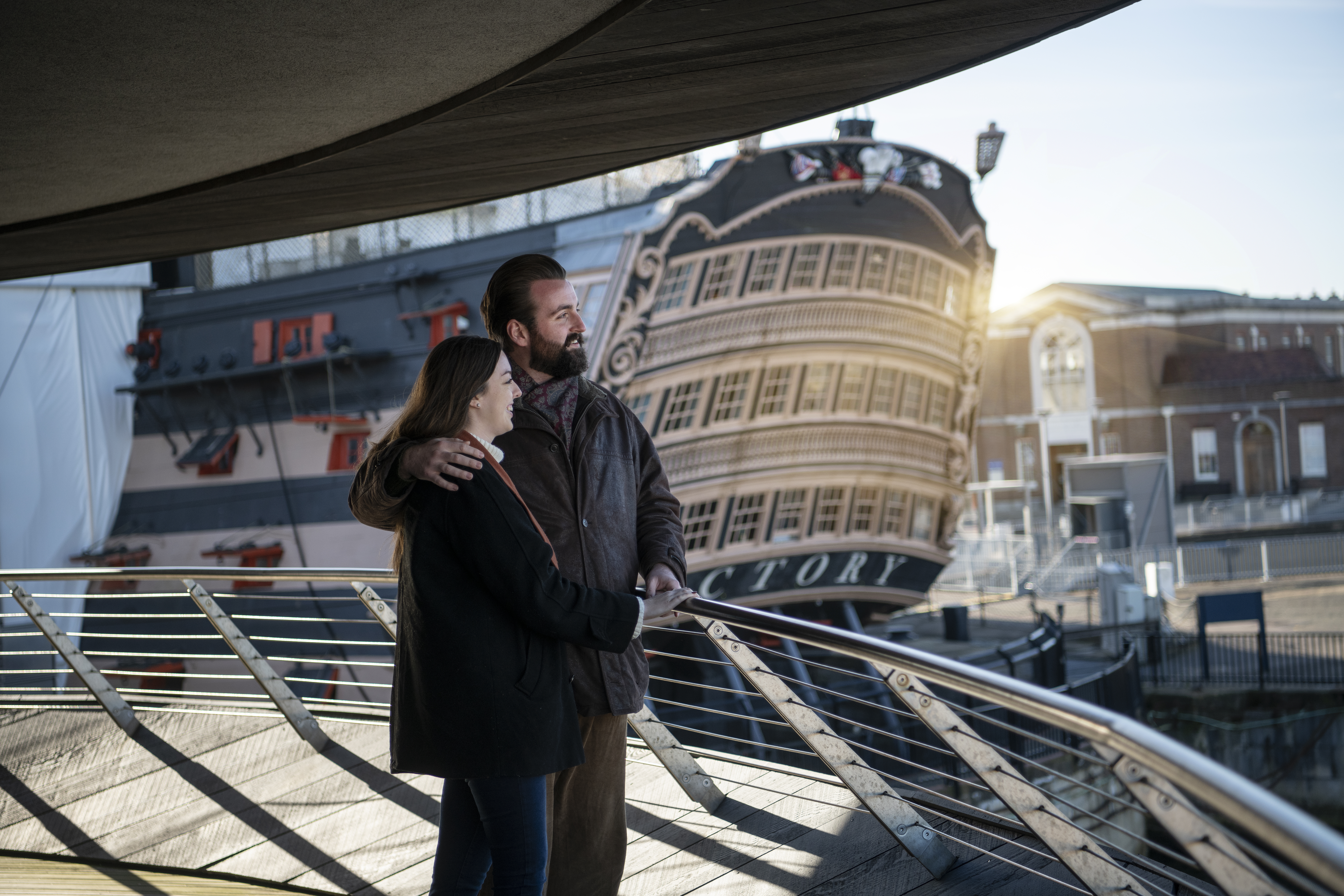 Two people looking over the bow of a ship
