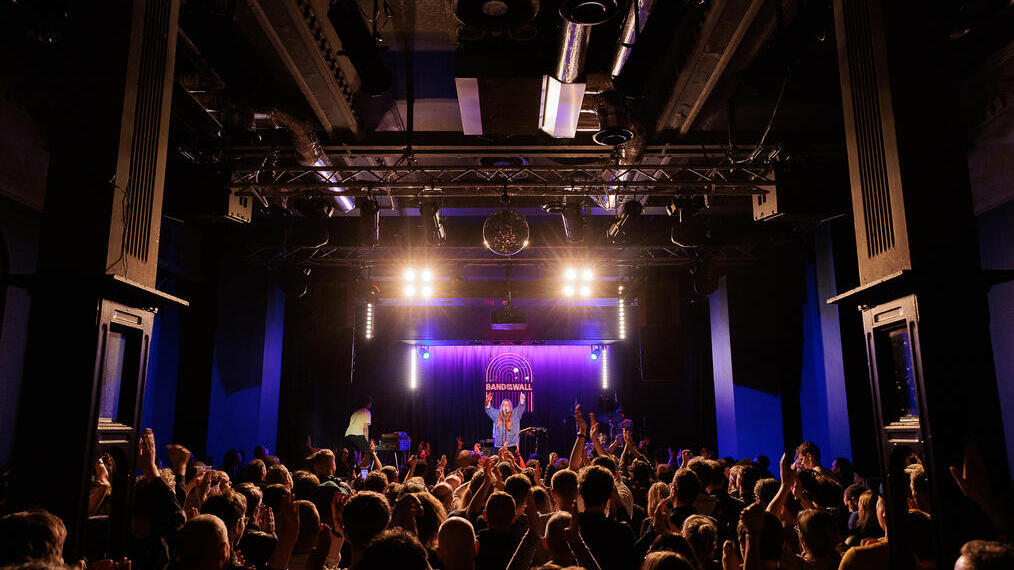 A live performance on stage at Band on the Wall in Manchester