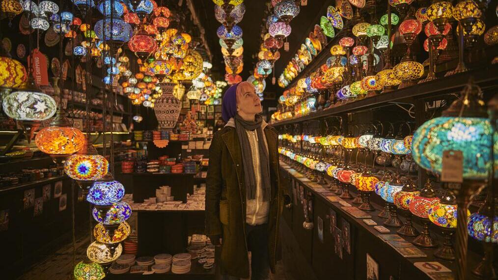 One young woman standing in a lighting shop