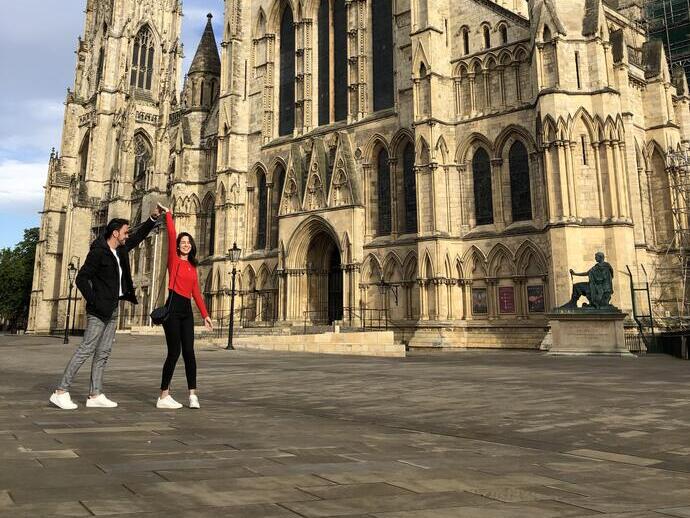 Man and woman dancing outside an historic building