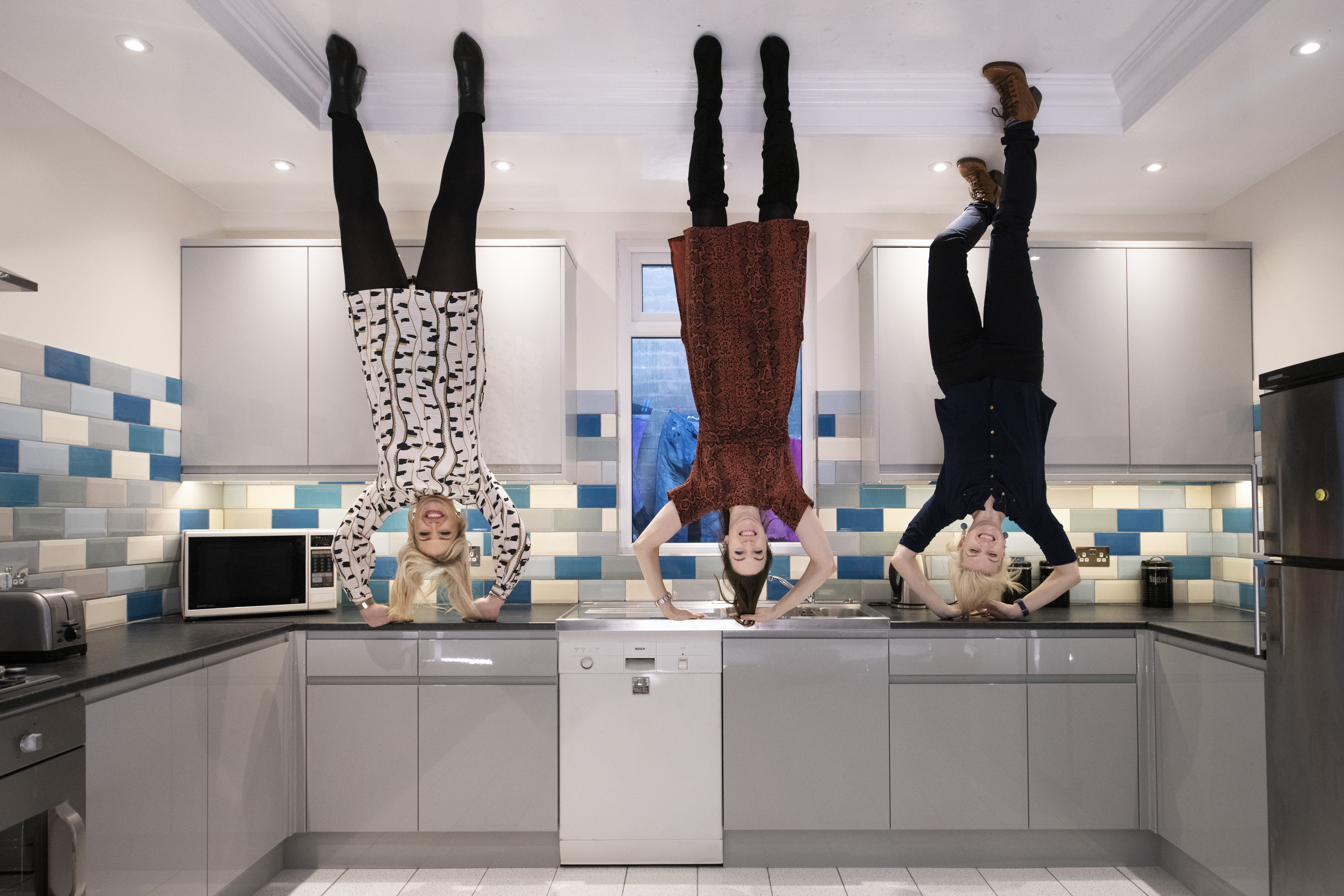 People posing in an upside down room at Liverpool's Quirky Quarter