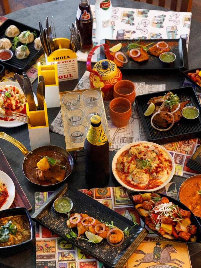 A feast of Indian food displayed on a table.