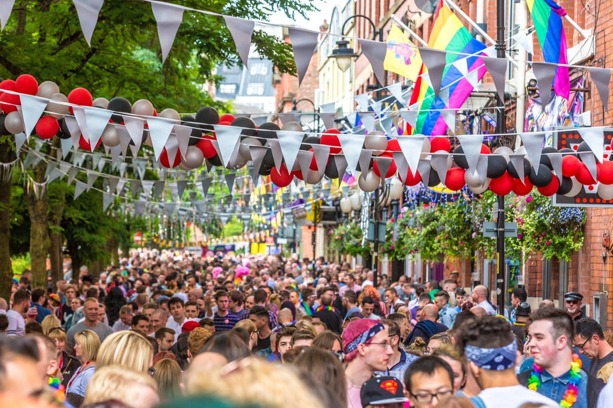Crowds of people walking along Manchester's Canal Street
