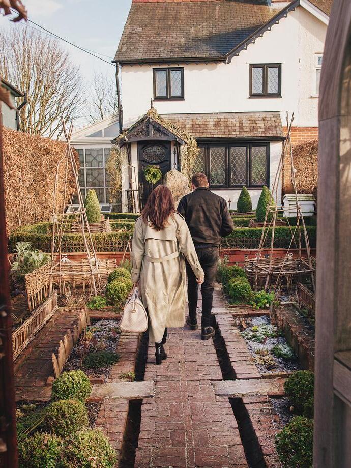Man and woman walking towards a house