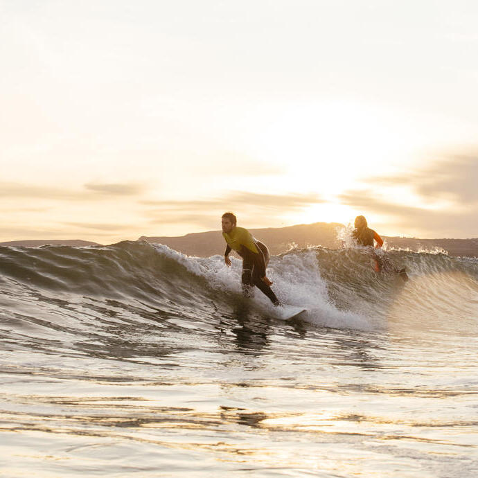 Homme et femme surfant dans la mer