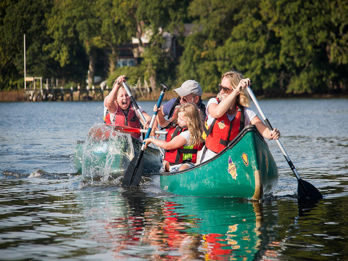 Family with children canoeing on a river