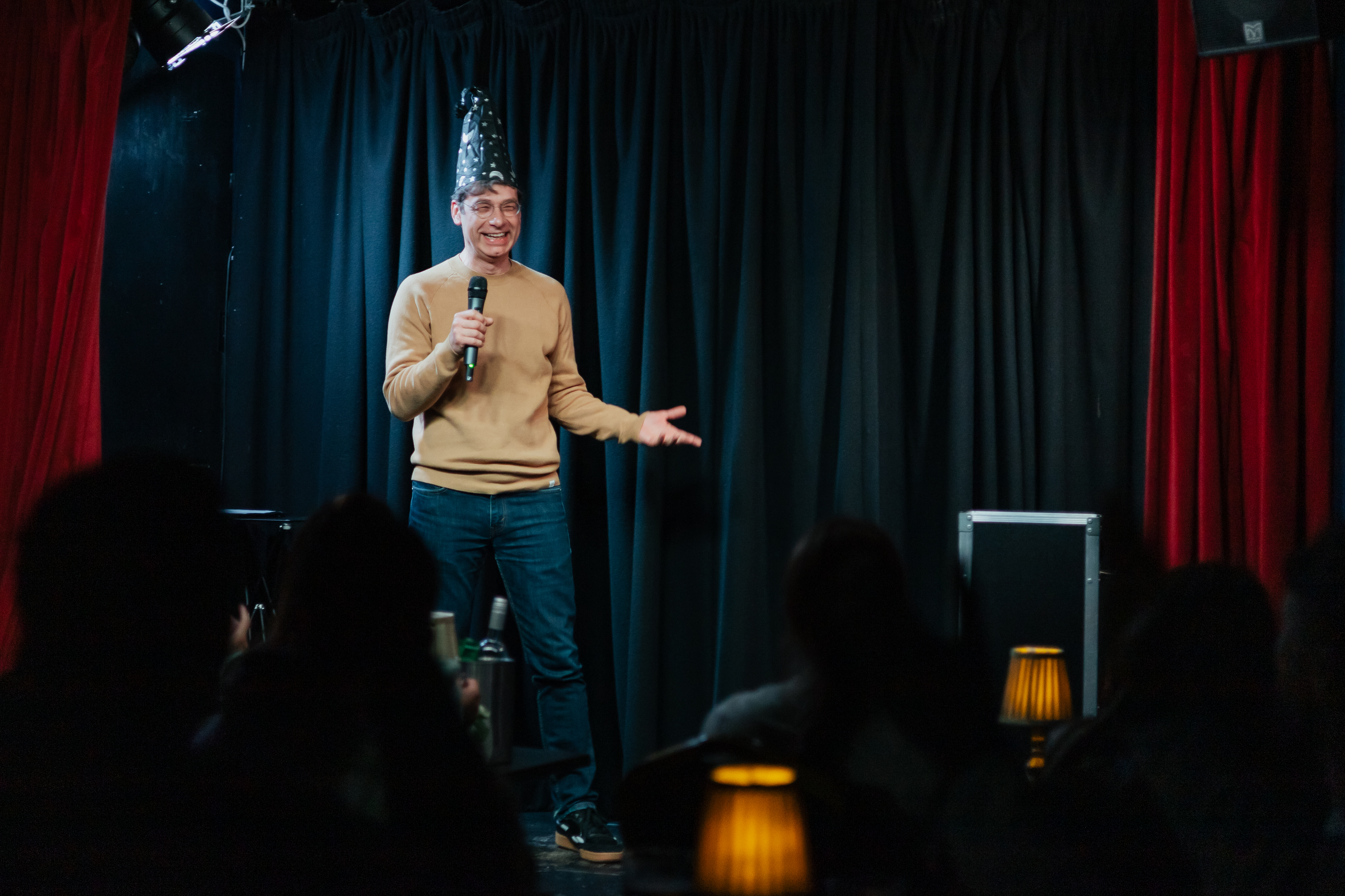 Man on stage performing a magic routine