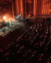 A band performing on stage at the Forum in Bath