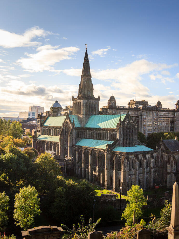 Aerial view of a cathedral on a sunny day with trees surrounding it