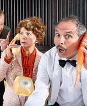 Actors in costume on the set of a farcical play.