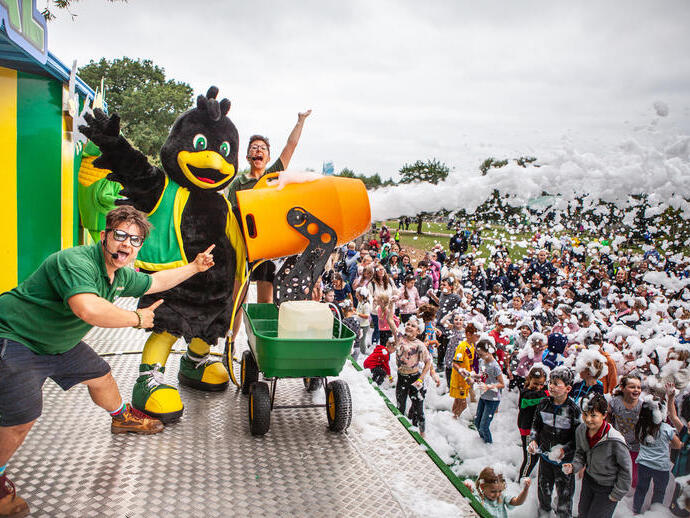 Performers on stage at York Maze shooting foam from a cannon