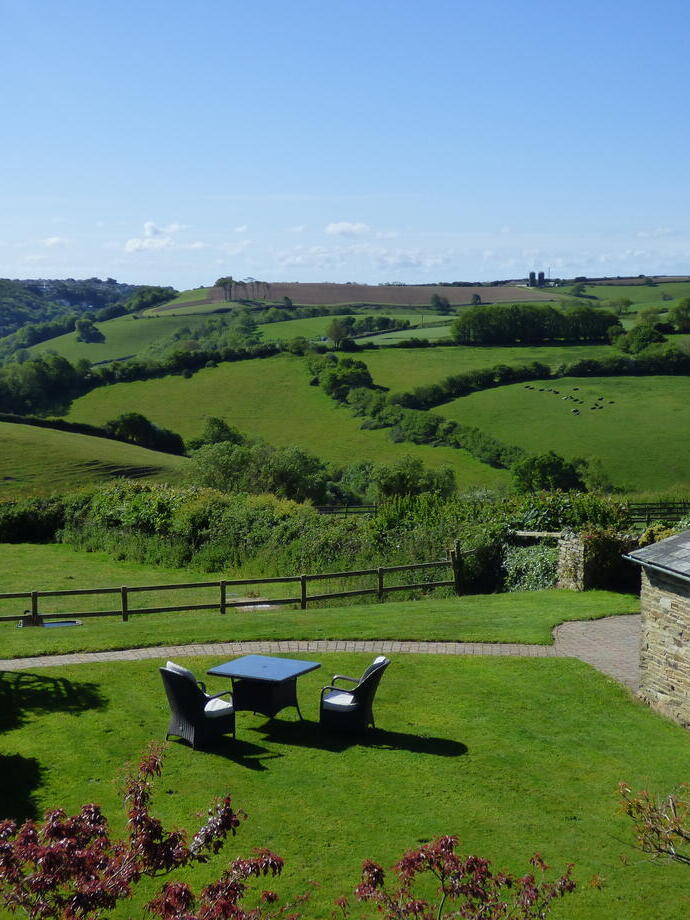 Outside garden and table setting at some luxury farm style cottages on the coast and countryside.
