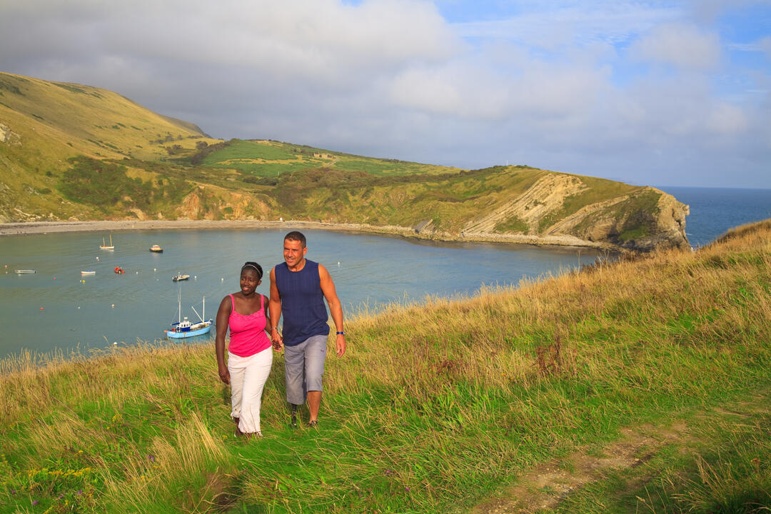 A couple walking on the clifftop.
