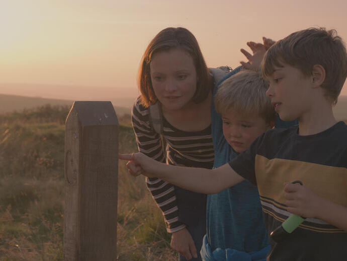 A mother and her two sons exploring the Dark Sky Discovery Trail in Exmoor Park
