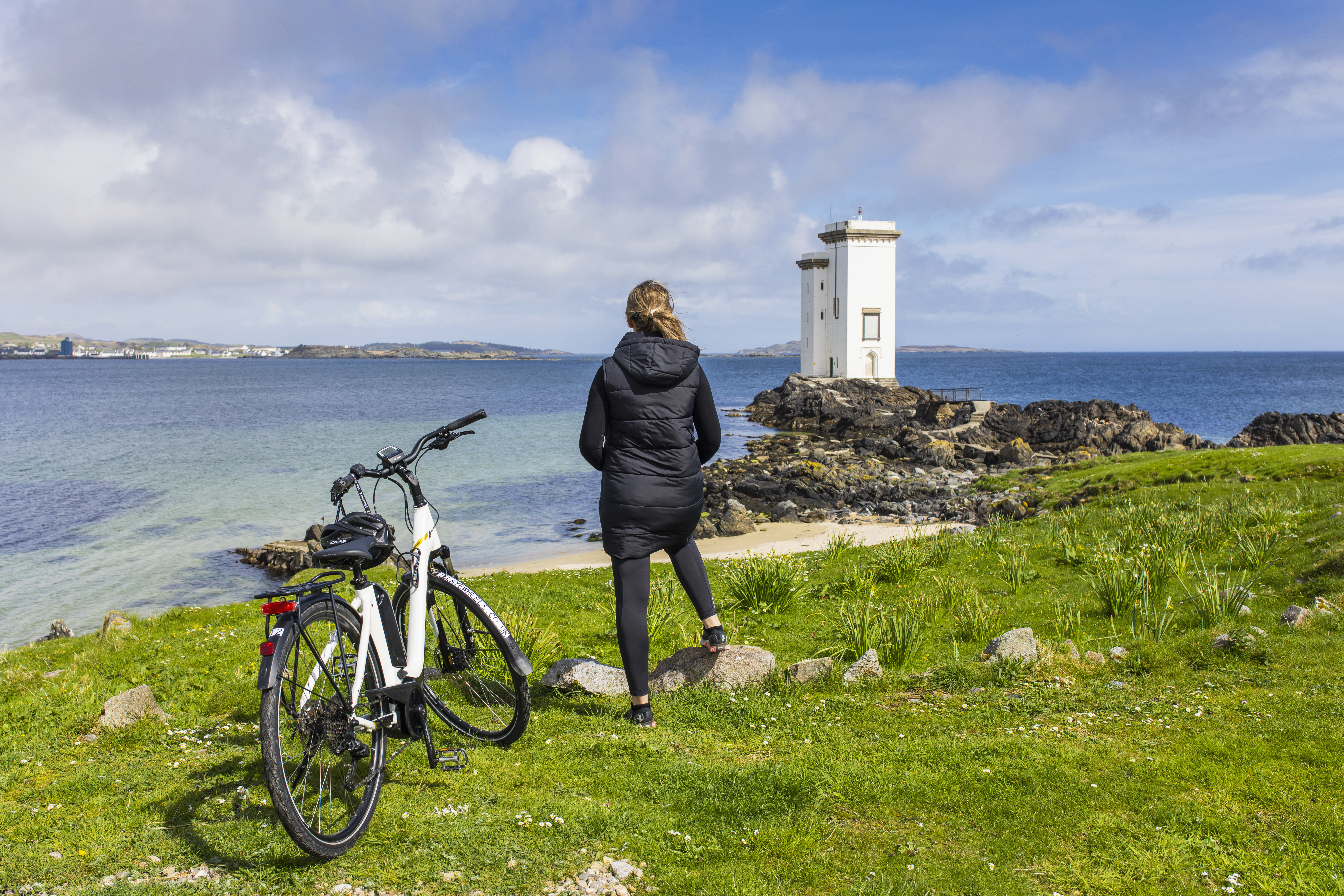 A woman exploring the Isle of Islay via electric bike