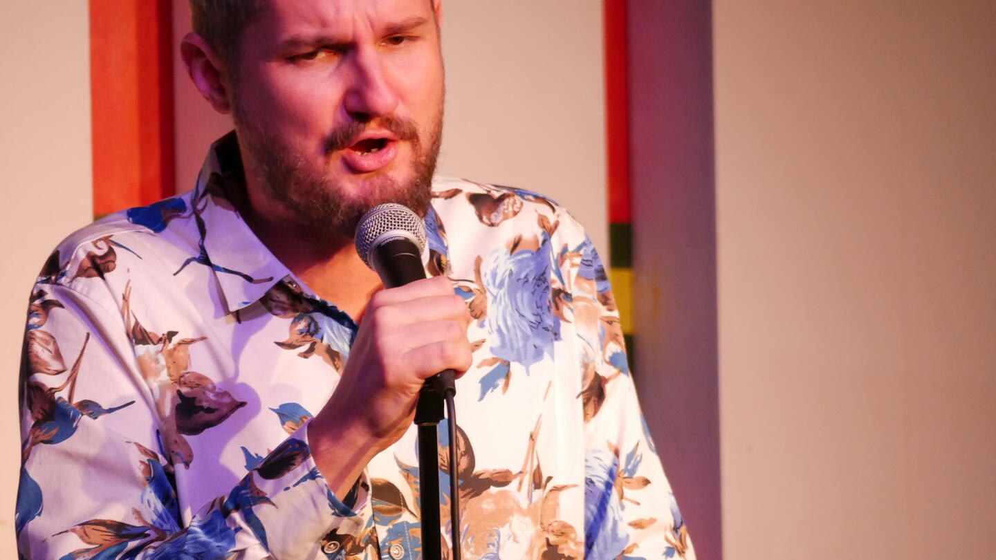 A man with a microphone at Birmingham Comedy Festival (autumn)