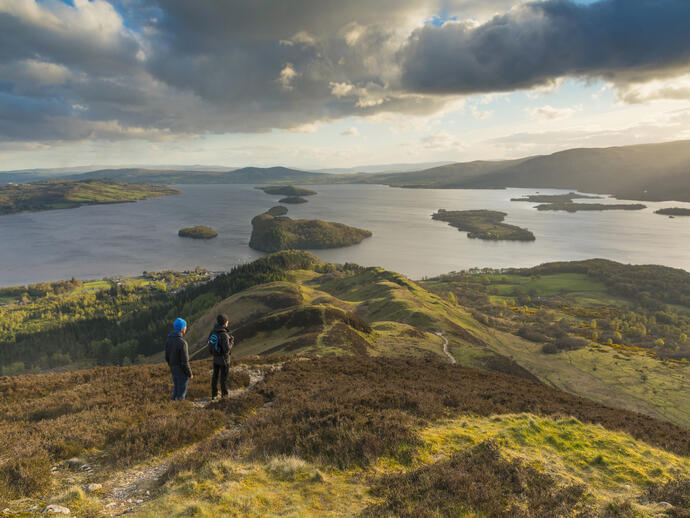 Walkers taking in the view of Loch Lomond from Conic Hill part of the West Highland Way