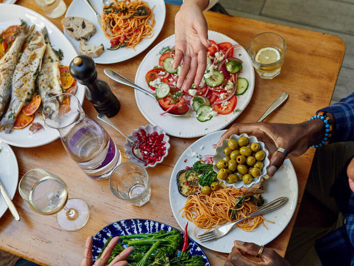 A group of people enjoy a meal at a table