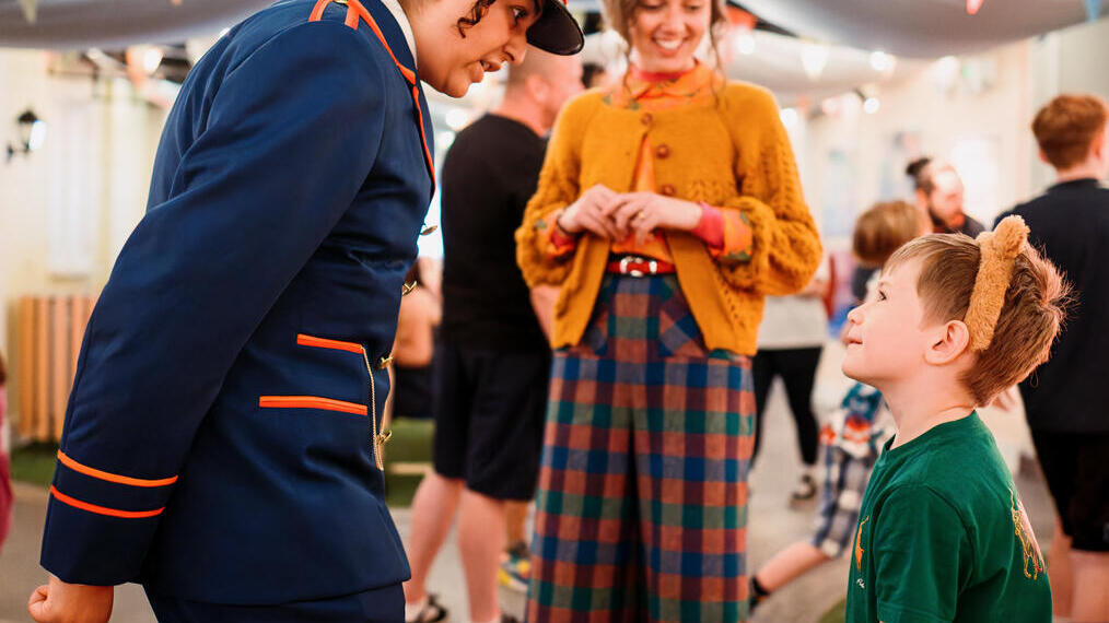 Character actors talking to a young child.