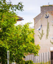 A street art mural on the side of a house.