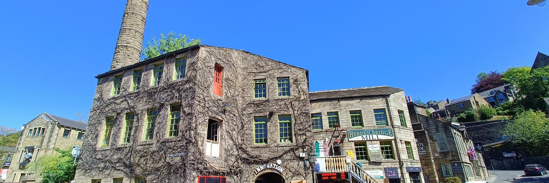 A village mill with passing pedestrians in the centre of an historic country village
