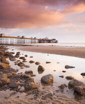 Pier built out into the sea in grand Edwardian style at dusk