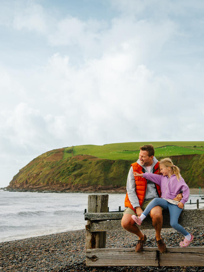 Father and daughter having fun on a beach