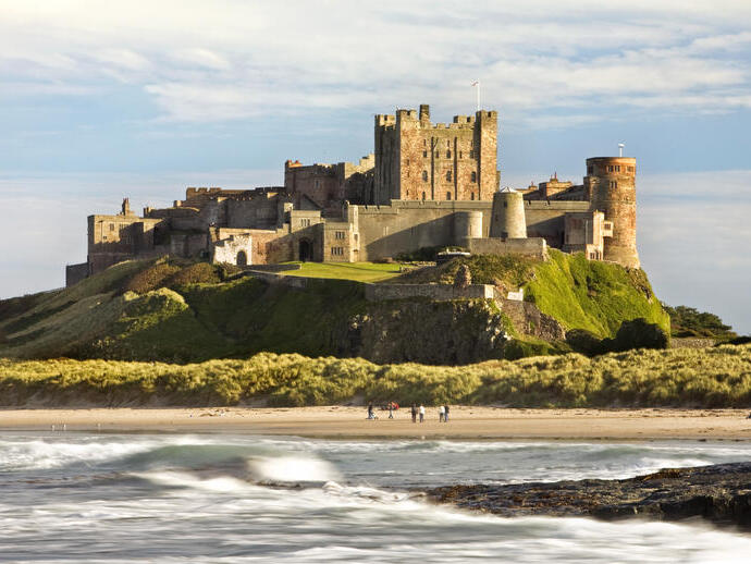 A castle on a cliff by a beach