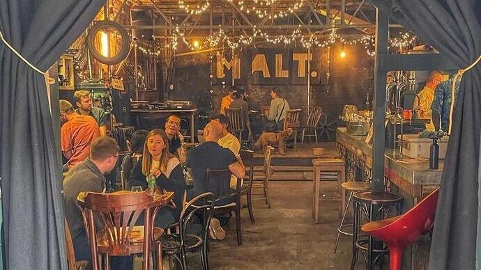 People sitting and drinking at Maltby Street Market