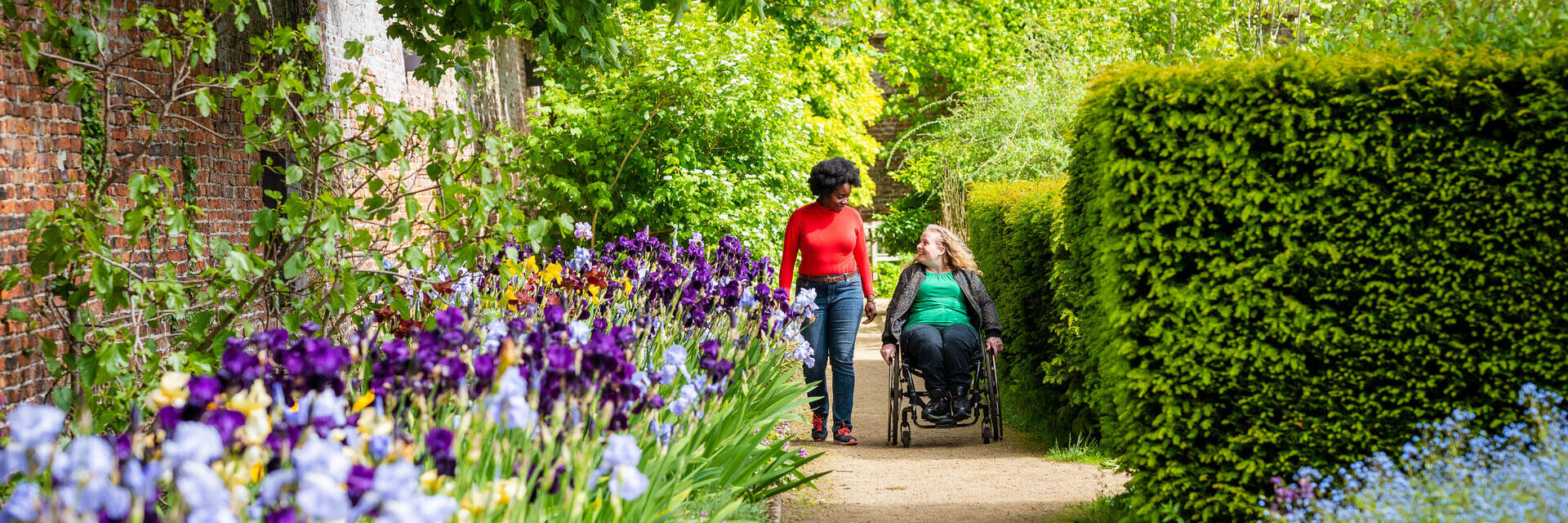 Two women in a Walled Garden, one using a wheelchair