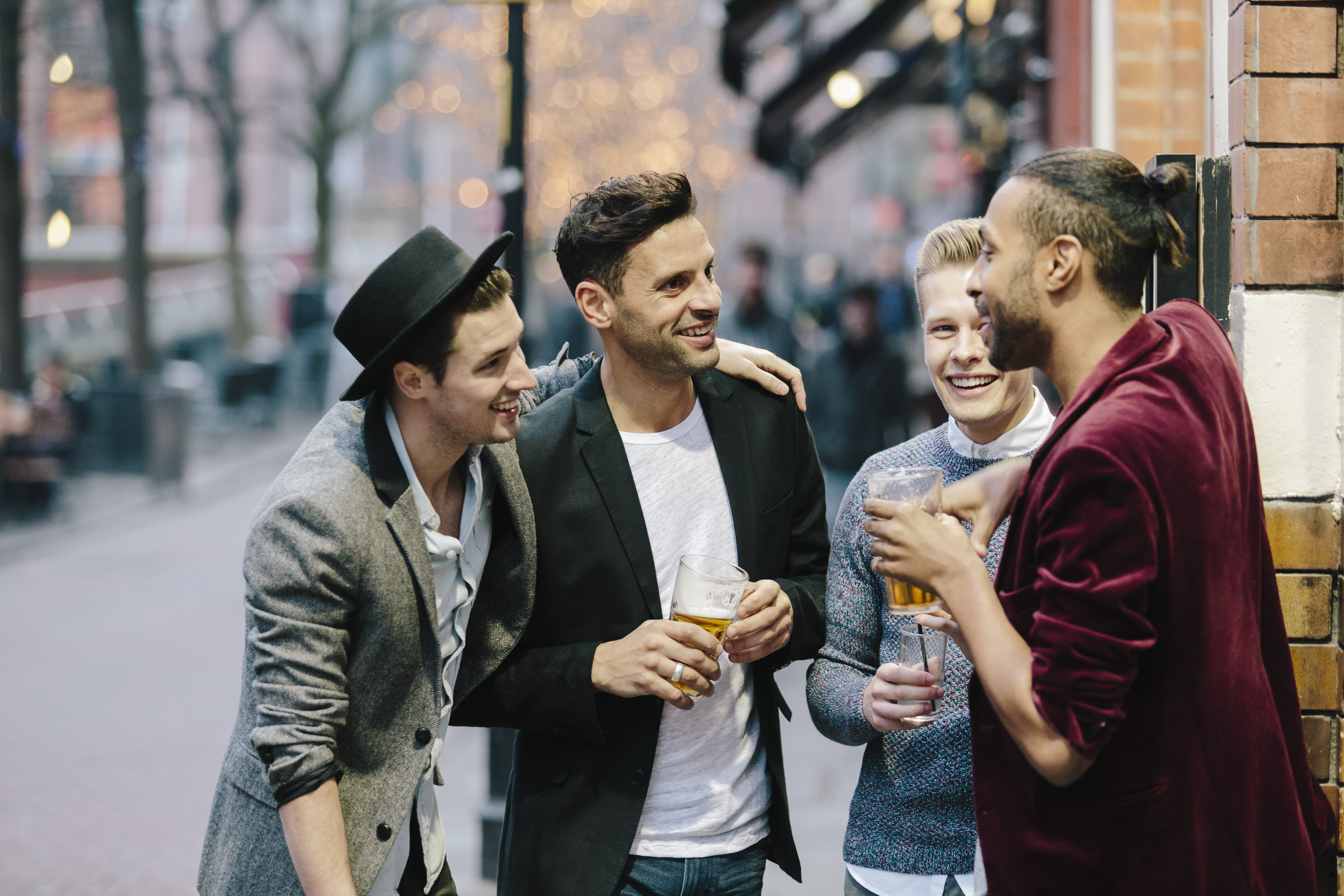 Gay couples standing together and having drinks
