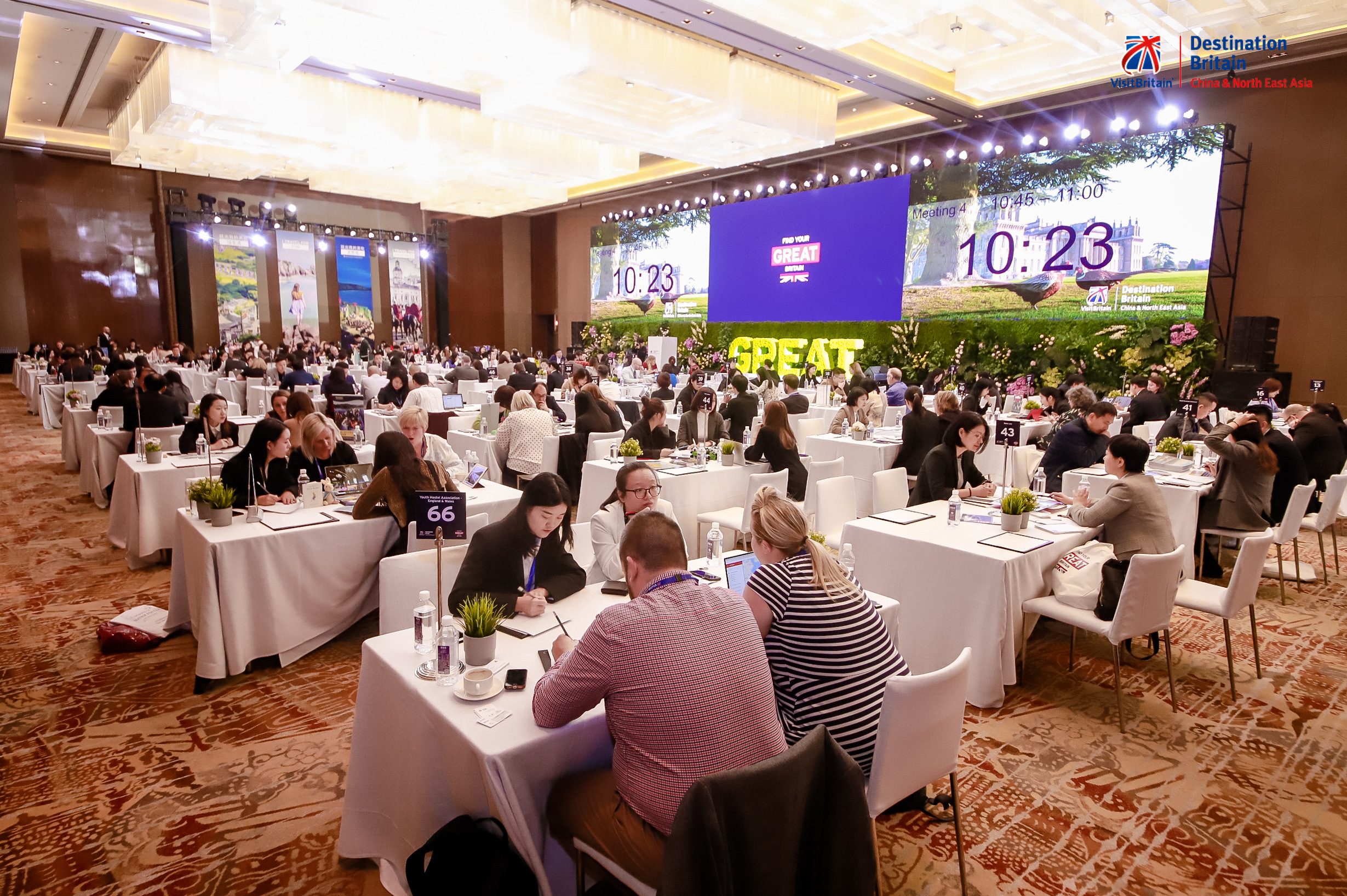 Groups of people sitting at tables discussing business at Destination Britain China