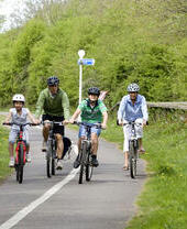 A group of people cycling along a path in Bristol