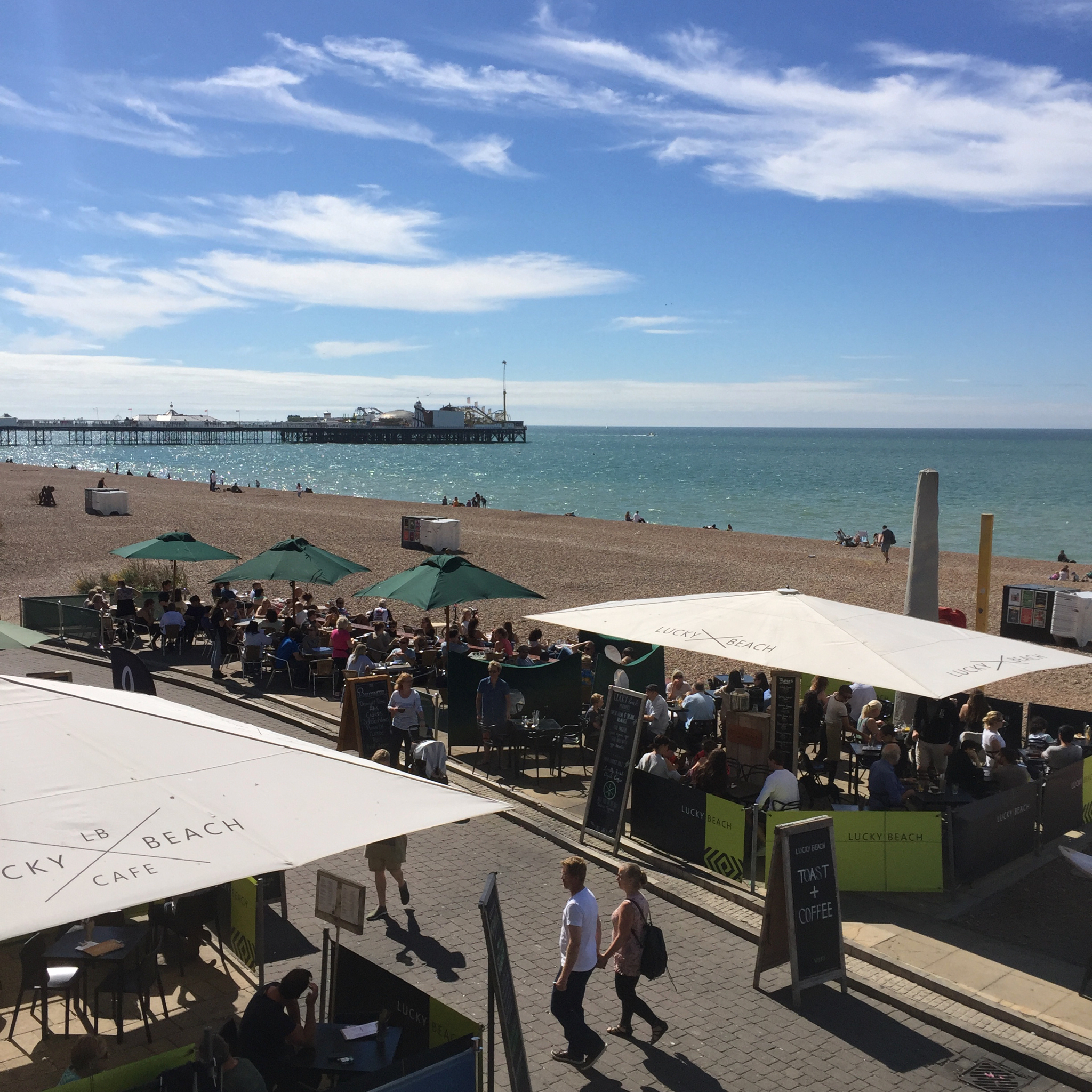 A view above Lucky Beach Café on Brighton beach with views of the pier behind
